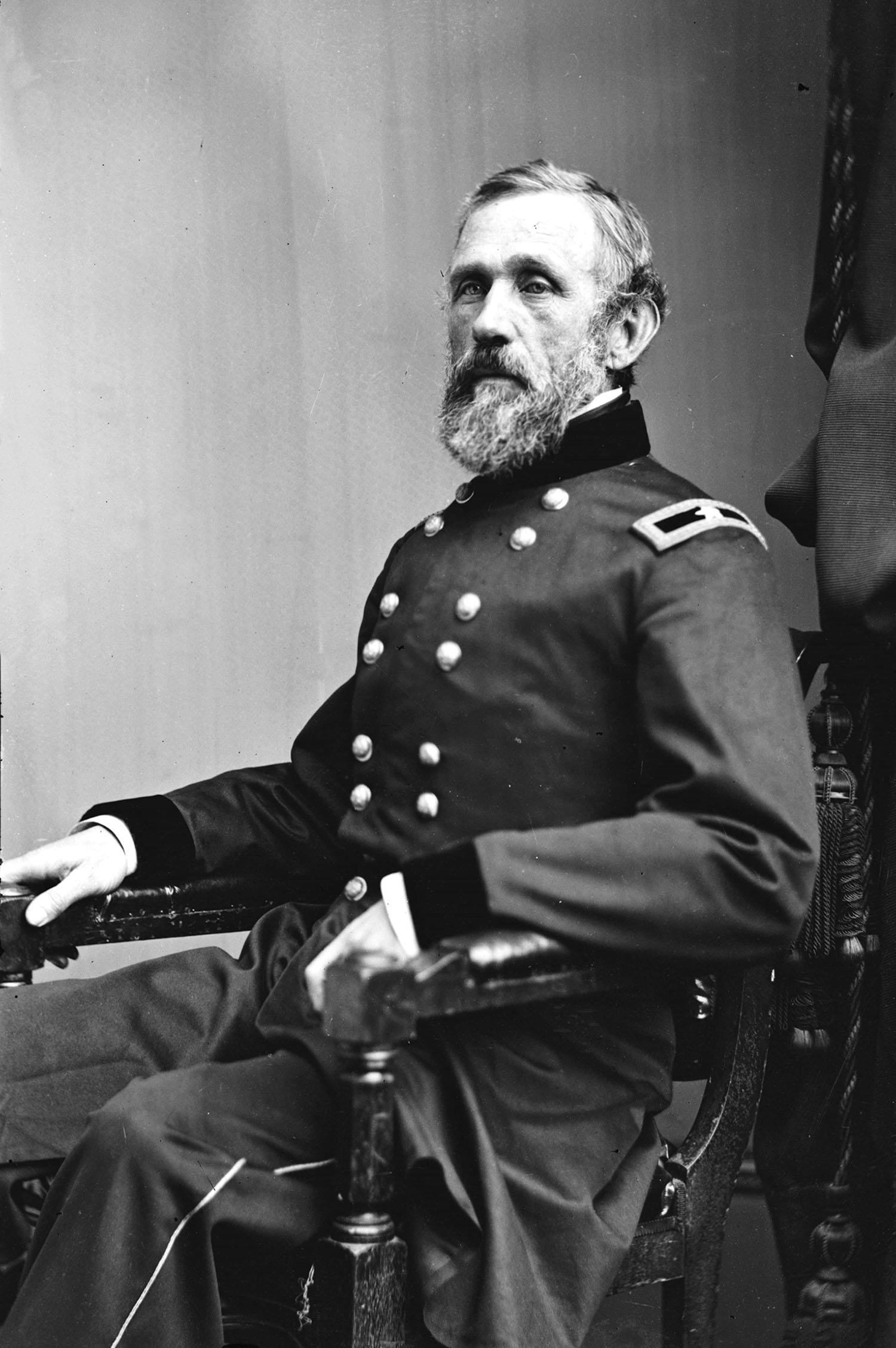 bearded man in uniform seated facing to his right bearded man in uniform seated facing to his right